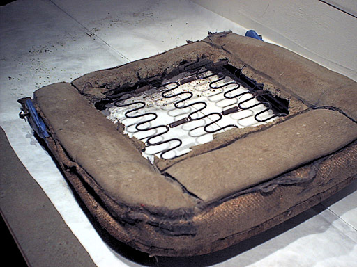 Cover removed from seat; padding has rotted away in the center